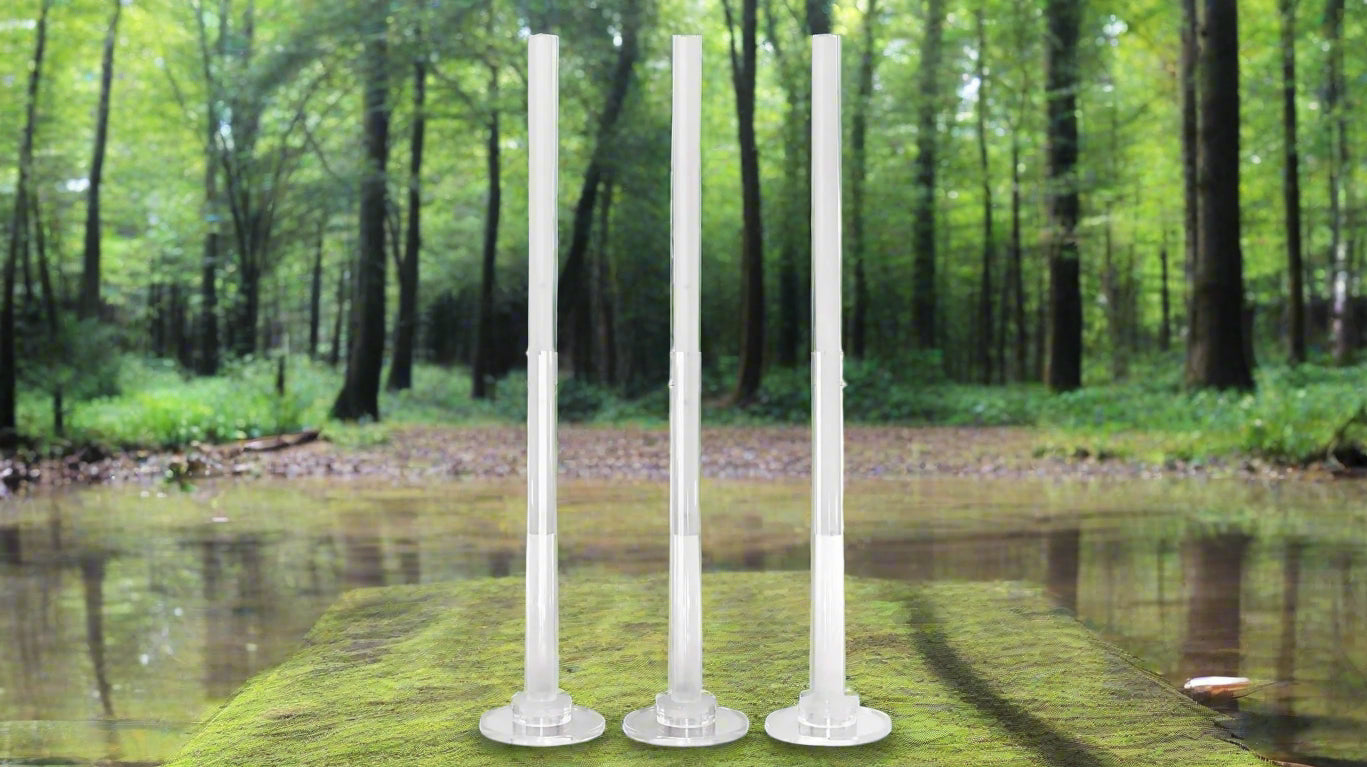 3 acrylic tubes and bases with a forest background which are the orynoco wholeness support unit v4