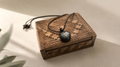 pendant necklace on carved wooden box